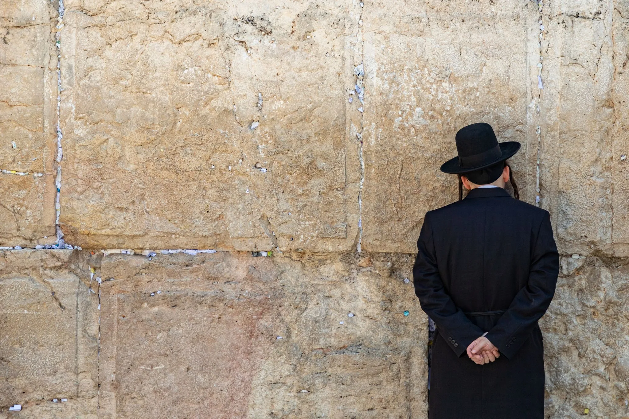 Jewish man praying at the wailing wall
