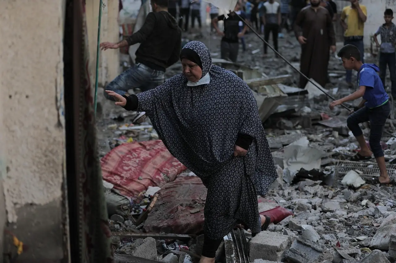 Muslim women in the middle of the ruins of Gaza